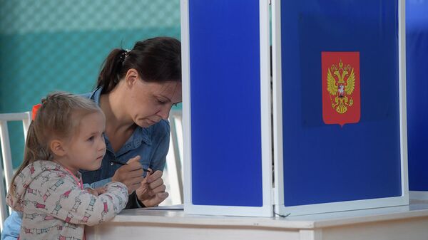 Девушка голосует на выборах Девушка голосует на выборах