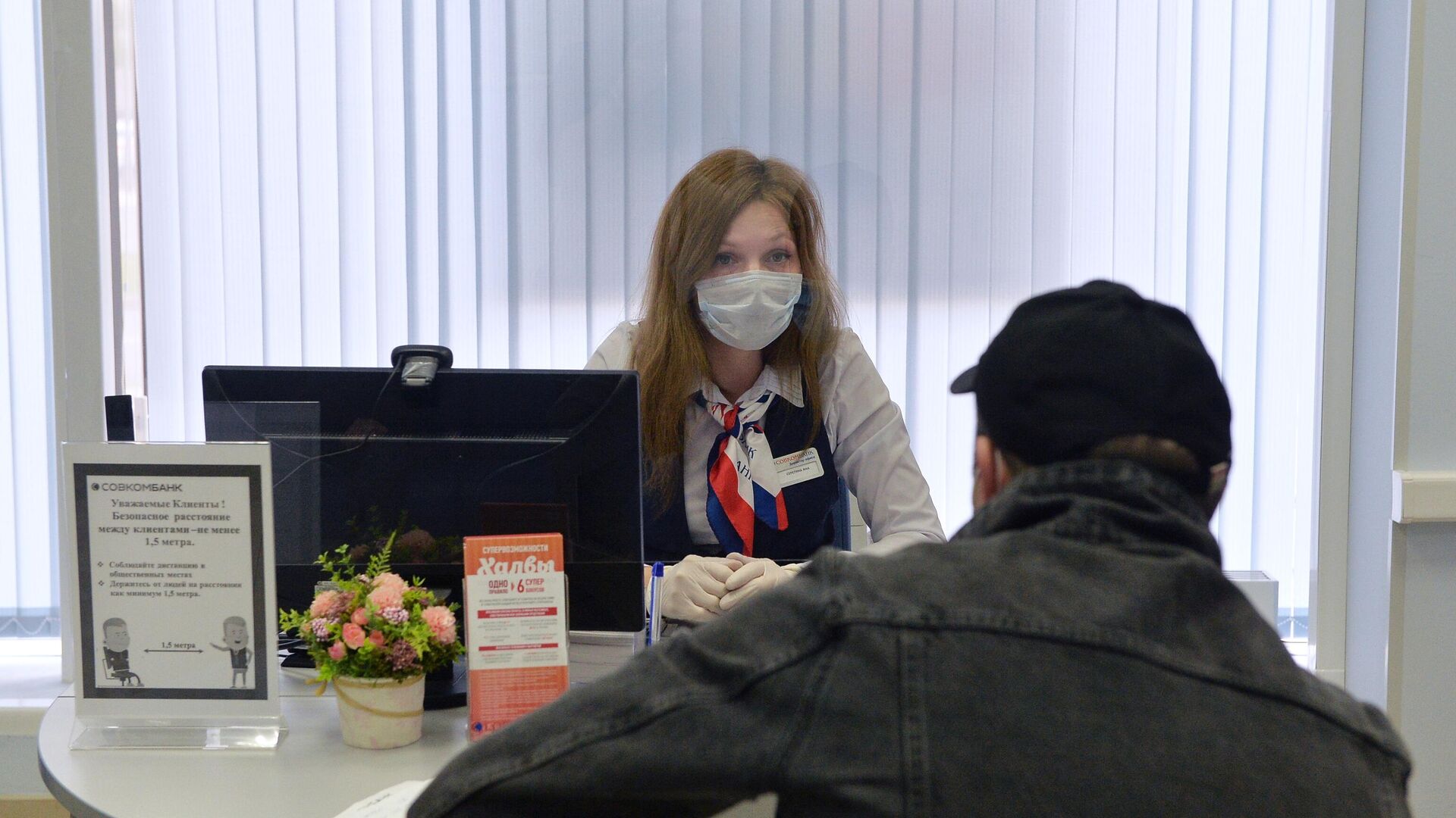 Сотрудница и клиент в отделении банка Совкомбанк в Москве Сотрудница и клиент в отделении банка Совкомбанк в Москве - РИА Новости, 1920, 13.01.2021