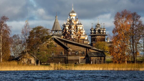 Вид со стороны Онежского озера на Преображенскую церковь XVIII века, церковь Покрова Пресвятой Богородицы и колокольню, входящих в состав архитектурного ансамбля Государственного историко-архитектурного музея-заповедника Кижи в Карелии Вид со стороны Онежского озера на Преображенскую церковь XVIII века, церковь Покрова Пресвятой Богородицы и колокольню, входящих в состав архитектурного ансамбля Государственного историко-архитектурного музея-заповедника Кижи в Карелии