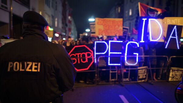 Марш демонстрации в Германии против нетерпимости к мигрантам и радикального движения Pegida. Архивное фото Марш демонстрации в Германии против нетерпимости к мигрантам и радикального движения Pegida. Архивное фото