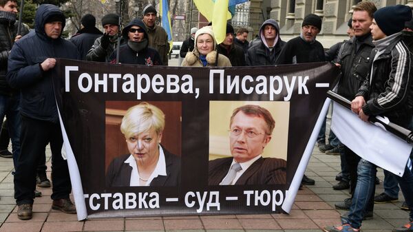 Участники акции протеста у Нацбанка Украины в Киеве, на плакате справа бывший первый замглавы Национального банка Александр Писарук Участники акции протеста у Нацбанка Украины в Киеве, на плакате справа бывший первый замглавы Национального банка Александр Писарук