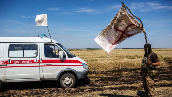 Украинский военный с белым флагом во время передачи убитых на нейтральной территории вблизи поселка Диброво возле российско-украинской границы в Донецкой области, 29 июля 2014 Украинский военный с белым флагом во время передачи убитых на нейтральной территории вблизи поселка Диброво возле российско-украинской границы в Донецкой области, 29 июля 2014