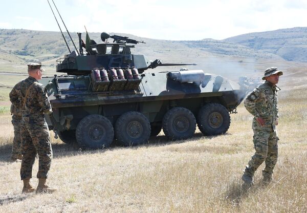 Военнослужащие рядом с легкой бронированной машиной LAV-25 во время учений Agile Spirit-2016 под эгидой НАТО на полигоне Орфоло в Грузии Военнослужащие рядом с легкой бронированной машиной LAV-25 во время учений Agile Spirit-2016 под эгидой НАТО на полигоне Орфоло в Грузии