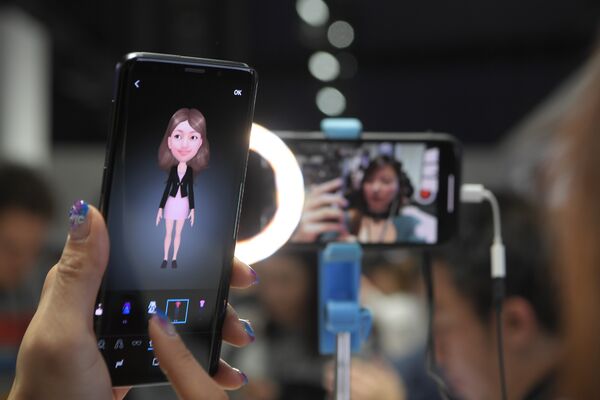 Женщина держит новый смартфон Samsung Galaxy S9 во время мероприятия Samsung Galaxy S9 Unpacked накануне MWC в Барселоне, Испания. 25 февраля 2018 года Женщина держит новый смартфон Samsung Galaxy S9 во время мероприятия Samsung Galaxy S9 Unpacked накануне MWC в Барселоне, Испания. 25 февраля 2018 года