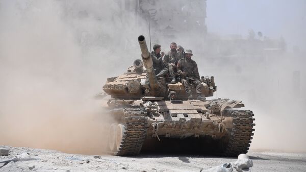 Soldiers of the Syrian army on a T-72 tank in the south of Damascus