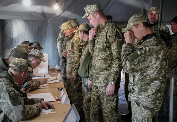 Украинские военнослужащие во время голосования на одном из избирательных участков в Донецкой области в день второго тура выборов президента Украины Украинские военнослужащие во время голосования на одном из избирательных участков в Донецкой области в день второго тура выборов президента Украины