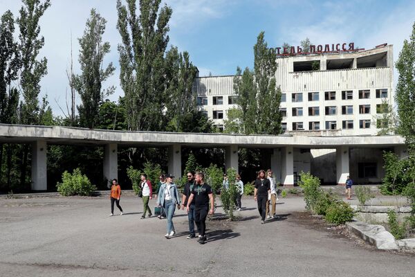 Туристы гуляют в заброшенном городе Припять, недалеко от Чернобыльской АЭС, Украина. 2 июня 2019 года Туристы гуляют в заброшенном городе Припять, недалеко от Чернобыльской АЭС, Украина. 2 июня 2019 года