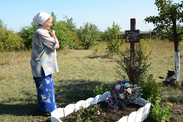 Женщина у мемориального креста на месте гибели фотокорреспондента Международного информационного агентства Россия сегодня Андрея Стенина Женщина у мемориального креста на месте гибели фотокорреспондента Международного информационного агентства Россия сегодня Андрея Стенина