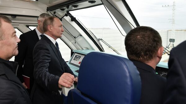 Президент РФ Владимир Путин во время поездки на рельсовом автобусе, который отправился по железной дороге Крымского моста Президент РФ Владимир Путин во время поездки на рельсовом автобусе, который отправился по железной дороге Крымского моста