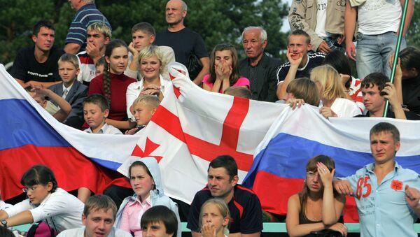 Люди с флагами России и Грузии Люди с флагами России и Грузии