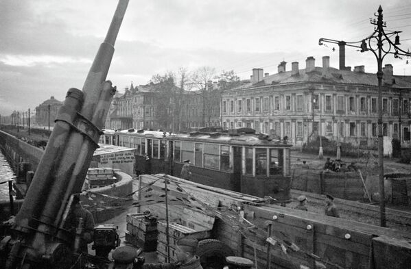 Зенитная установка и трамвай № 12 на улицах города. Ленинград октябрь 1942 года Зенитная установка и трамвай № 12 на улицах города. Ленинград октябрь 1942 года